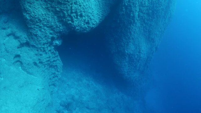 a cave enterance deep on te reef underwater 