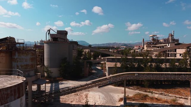 Abandoned cement factory aerial view showing industrial decay and rusty silos
