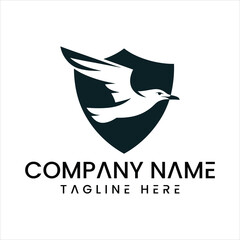 Fototapeta premium Black and white logo of a bird flying in front of a shield