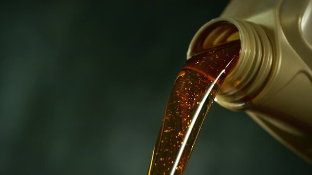 Super Slow Motion of Pouring Fresh New Motor Oil into Car's Engine. Filmed on High Speed Cinema Camera  