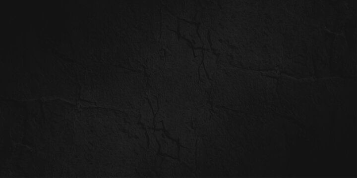 A dark aged grunge wall texture with a vintage black concrete pattern and rough gray material backdrop for a dirty blank wallpaper design