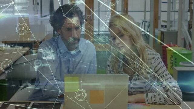 Man starting discussion by pointing laptop team reviewing tech data while HUD charts sweeping hands