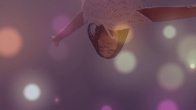 Camera starting woman rotating above lens, revealing dress while bokeh obscuring face for fashion