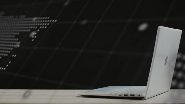 Vertical video: Camera pulling back revealing laptop, dotted map and scrolling text for tech demo