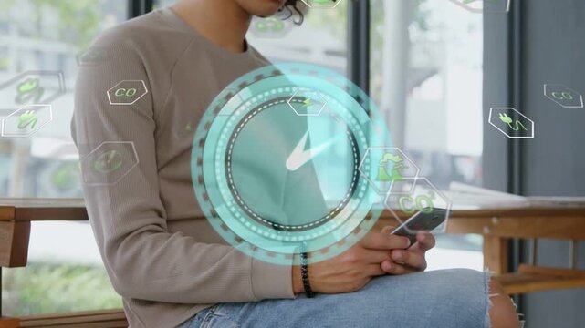 Tapping smartphone, man in pullover and ripped jeans using AR HUD on stool by window, wristband