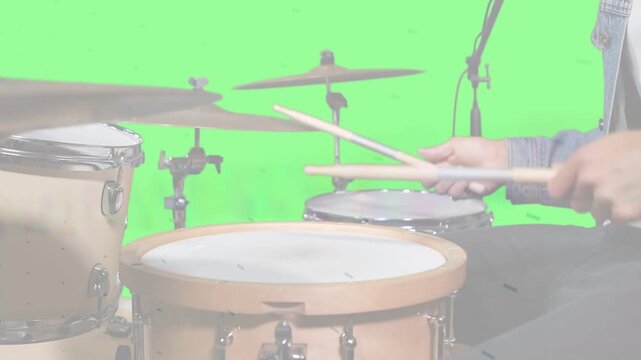 Drummer striking sticks, creating animated beat waves from hits on green screen for music tutorial