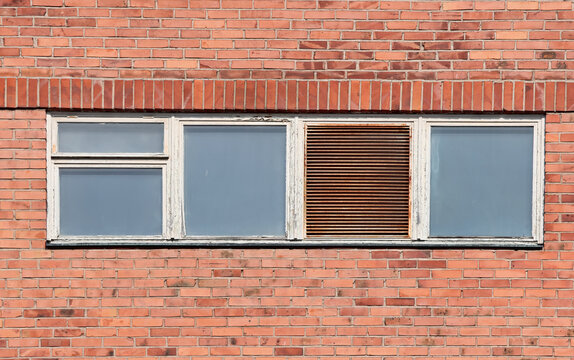 Four small windows on an old factory building