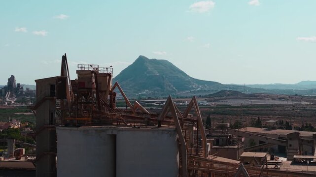 Abandoned cement factory with old rusty machinery and conveyor belts