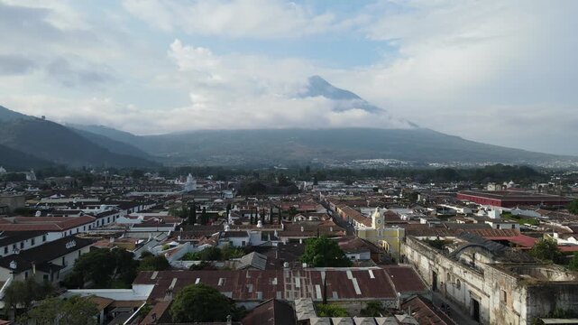 Hermosa vista desde Guatemala Antigua. Beautiful aerial footage of the colonial town of Antigua Guatemala. The Yellow arch clock of Santa Catalina Convent, Cathedral.