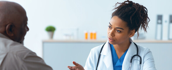 A doctor speaks with a patient in a medical office. The doctor is explaining health concerns while...