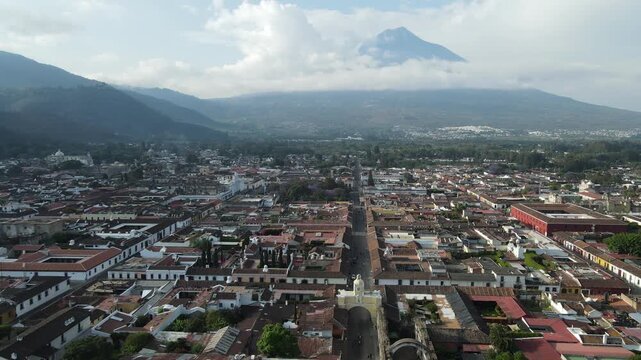 Hermosa vista desde Guatemala Antigua. Beautiful aerial footage of the colonial town of Antigua Guatemala. The Yellow arch clock of Santa Catalina Convent, Cathedral.