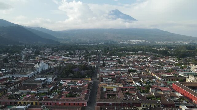 Hermosa vista desde Guatemala Antigua. Beautiful aerial footage of the colonial town of Antigua Guatemala. The Yellow arch clock of Santa Catalina Convent, Cathedral.