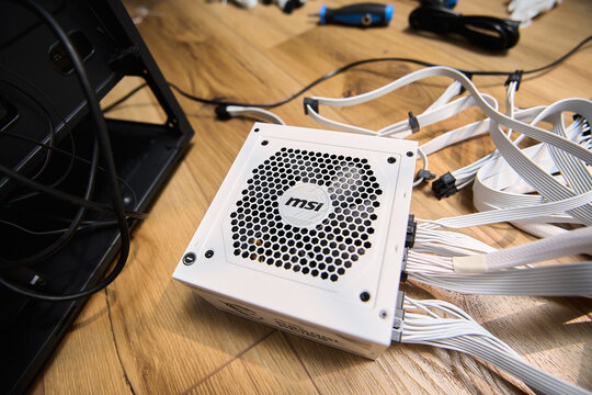 Tyumen, Russia-February 15, 2026: MSI power supply sits next to a black bag in a home workspace