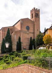 Obraz premium Basilica di San Domenico in Siena, Italy, historic building with cypress trees.