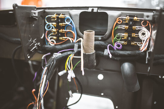 Close-up of vintage car dashboard wiring harness and fuse box