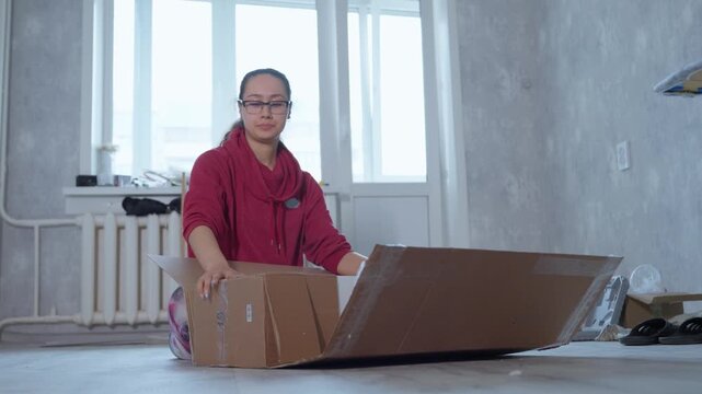 Final Check Of Contents. Sealing Box After Inspection. Performing Last Detailed Inspection Before Sealing Container. Woman Carefully Verifies All Items Before Closing And Sealing Box Securely