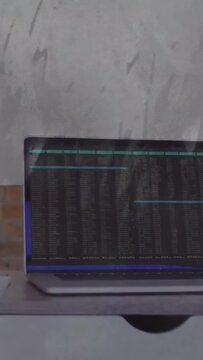 Vertical video: Laptop showing terminal while wavy overlay moving, hand making glare for tech test