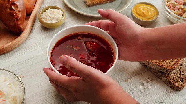 Beetroot soup, Cooking traditional national Slavic Russian, Ukranian soup Borsch close-up. Boiling red soup with vegetables and turkey meat and spices. Special red for Borsh from beet, tomatoes pasta