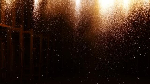Slow motion static pan tilt view of sparks and ember shower falling over industrial scaffold inside dark stage studio