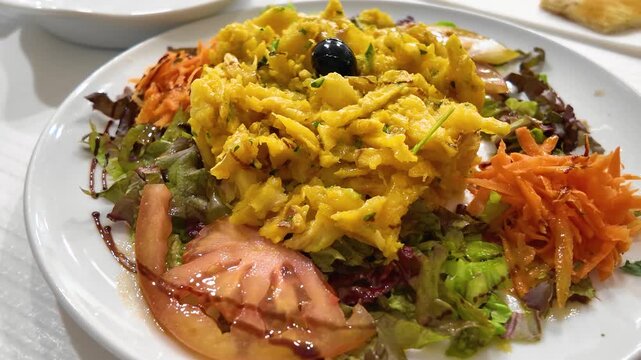 Overhead Shot: Delicious portuguese Traditional Codfish Dish Served on Restaurant Table