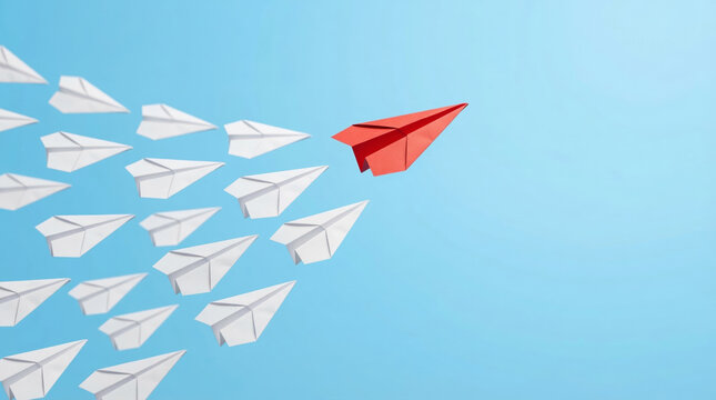 Red paper airplane leading a group of white planes representing leadership business success and innovation