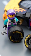 Naklejka premium Tambov, Russian Federation - January 17, 2026 Lego driver minifigure with wrench changing wheel of a Lego NASCAR Next Gen Chevrolet Camaro ZL car.