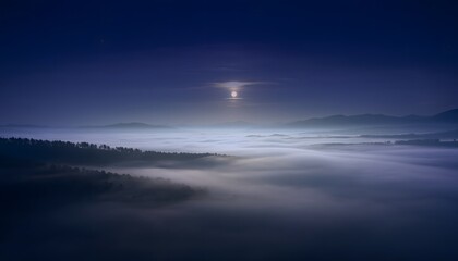 Fototapeta premium A breathtaking aerial view of a misty valley at dawn, with a bright sun piercing through the dense fog over a serene forest landscape.