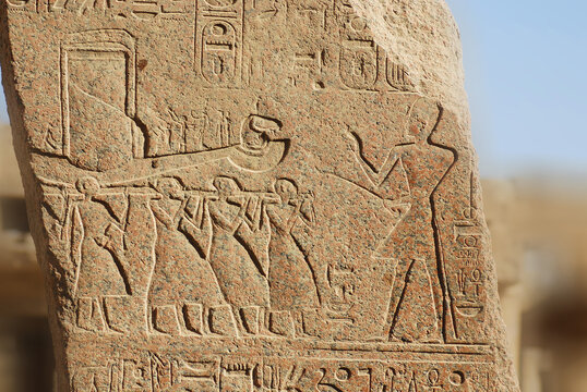 LUXOR EGYPT: Hieroglyphic carvings in the walls at of an Egyptian ancient temple. Hieroglyphs were logograms representing words using graphical figures such as animals, objects or people.