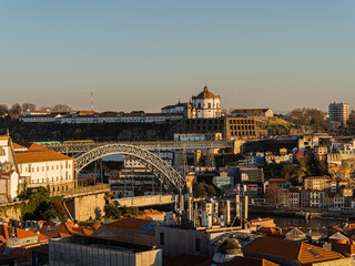 Porto reflecting golden sunlight over dom luis i bridge © Paul