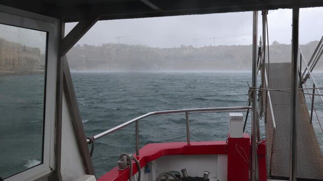 Heavy Rain Storm Over Grand Harbour Seen From Boat Deck With Valletta Fortification Walls in Background Malta