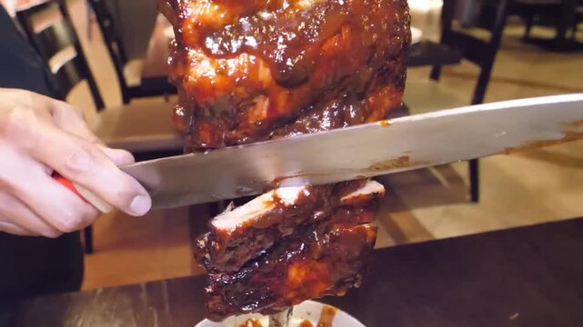 A close-up shot of a professional chef or "gaucho" slicing a perfectly cooked and seasoned picanha (top sirloin) steak directly from a large skewer, known as a sword, at a traditional Brazilian steakh