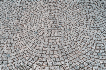 Fototapeta premium Cobblestone pavement pattern with curved layout, detailed cobblestone texture, masonry structure. Natural background featuring cobblestone texture for design, architecture, backdrop
