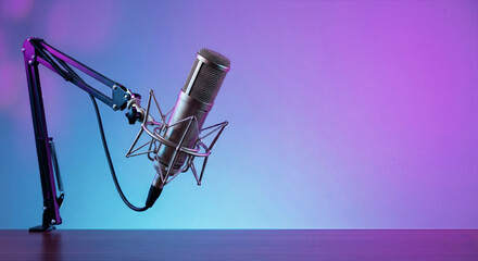 Fototapeta premium Professional Studio Condenser Microphone on Boom Arm with Shock Mount in Neon Blue and Purple Lighting Background