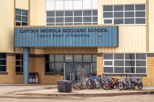Calgary, Alberta, Canada. April 15, 2026. Exterior of Captain Nichola Goddard School showing entrance signage and a bicycle rack area.
