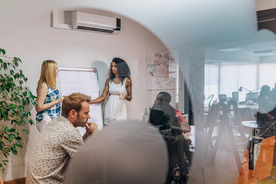 Diverse team meeting in modern office during presentation