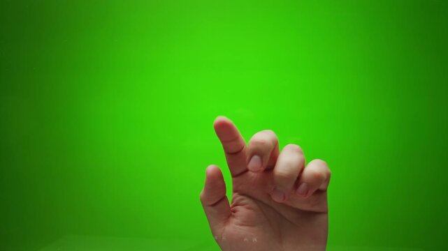 Male hand touching, making sign on document, clicking, tapping, sliding and swiping on chroma key green screen background. Different signs and gestures with fingers. 