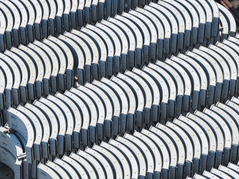 Aerial view of rows of curved precast concrete tunnel segments stacked in an industrial storage yard Taiwan.