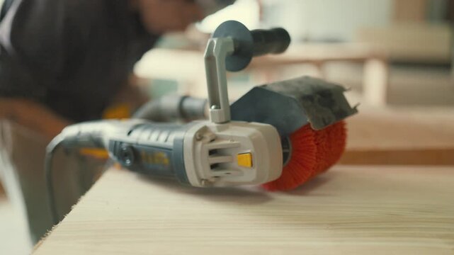 Power brush sander tool in carpentry workshop