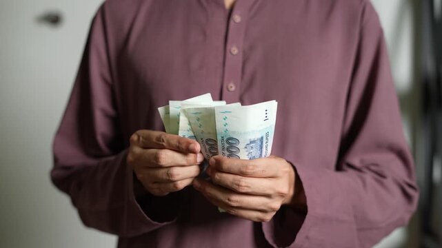 Hands Counting Pakistani Rupees for Payment Concept