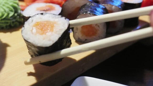 A beautifully arranged platter of assorted maki sushi rolls, featuring a colorful and delicious selection perfect for sushi enthusiasts.