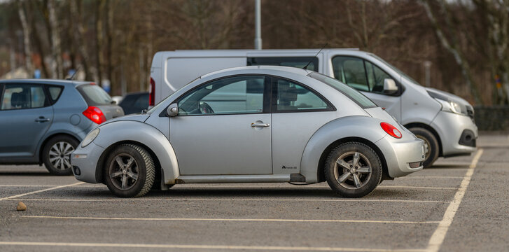 Gothenburg, Sweden - March 14 2026: White Volkswagen Beetle parked in outdoor parking lot among cars.