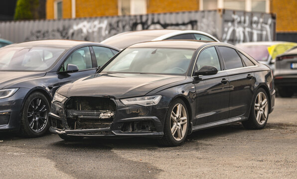 Gothenburg, Sweden - March 15 2026: Damaged black Audi sedan parked after urban traffic collision.
