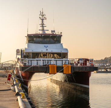 Gothenburg, Sweden - March 22 2026: Front view of modern catamaran ferry moored at harbor in calm water.
