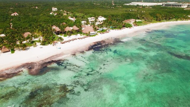 Aerial view of tropical beachfront resort with turquoise Caribbean water