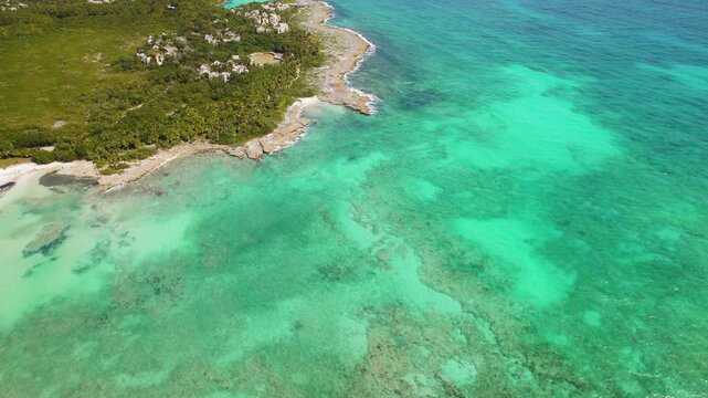 Rocky coast and turquoise Caribbean water with beach coves in Yucatan Mexico
