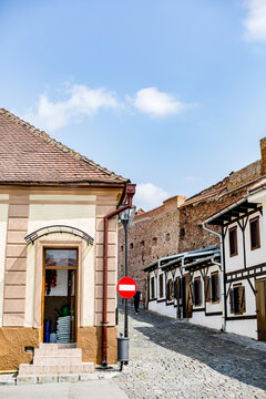 There is a red stop sign on the side of a street, beneath the open sky across Soala, Romania