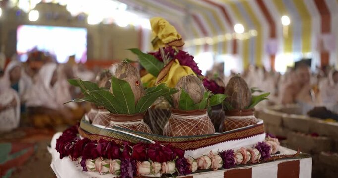 Close-up of aahuti being offered in hawan kund during pooja, showcasing flames, rituals, and sacred Hindu worship practices