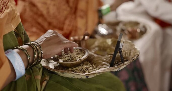Close-up of aahuti being offered in hawan kund during pooja, showcasing flames, rituals, and sacred Hindu worship practices