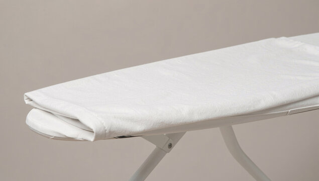 A white ironing board sits on a table, ready for use