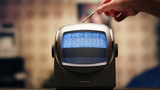 Retro TV, vintage television In a nostalgic setup, a retro TV displays grain on screen, scary halloween night device good for chroma key and green screen.
